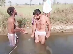 THREE MEN HAVING FUN BATHING OUTDOORS