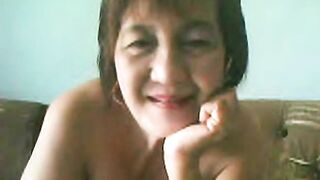 Bulky Granny Oriental Lady On Web Camera Showing Goods On Webcam